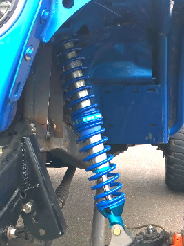 A photo of a blue King dual rate coilover installed on a Jeep